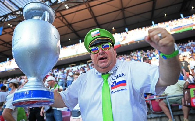 A Slovenian supporter poses for a photo before the UEFA Euro 2024 Group C football match between England and Slovenia at the Cologne Stadium in Cologne on June 25, 2024. (Photo by Kirill KUDRYAVTSEV / AFP)