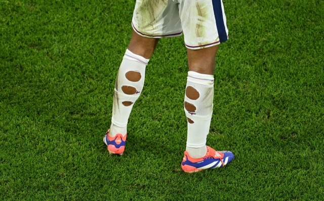 COLOGNE, GERMANY - JUNE 25: A detailed view of the rip socks of Jude Bellingham of England (obscured) during the UEFA EURO 2024 group stage match between England and Slovenia at Cologne Stadium on June 25, 2024 in Cologne, Germany. (Photo by Matthias Hangst/Getty Images)