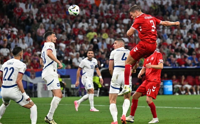 Denmark's defender #03 Jannik Vestergaard (R) heads the ball to the goal during the UEFA Euro 2024 Group C football match between Denmark and Serbia at the Munich Football Arena in Munich on June 25, 2024. (Photo by Miguel MEDINA / AFP)