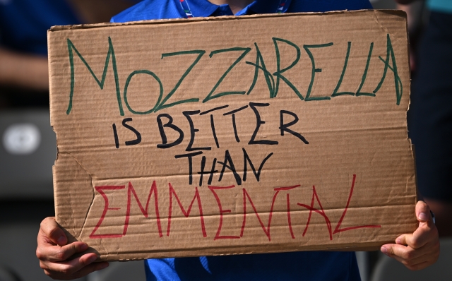 BERLIN, GERMANY - JUNE 29: A fan of Italy holds up a sign which reads "Mozzarella is better than Emmental" prior to the UEFA EURO 2024 round of 16 match between Switzerland and Italy at Olympiastadion on June 29, 2024 in Berlin, Germany. (Photo by Stu Forster/Getty Images)