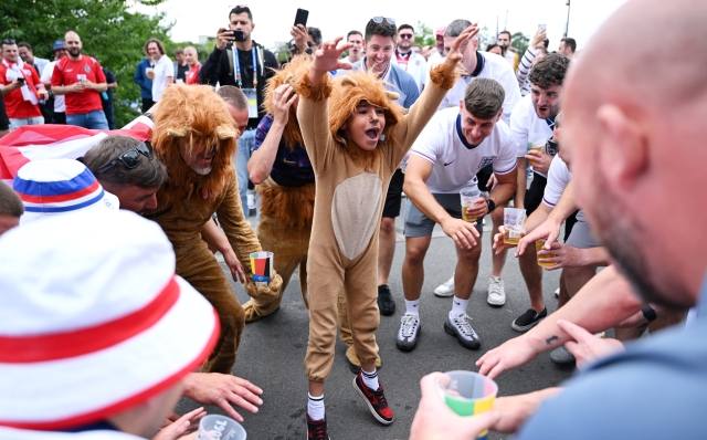 GELSENKIRCHEN, GERMANY - JUNE 30: Fans of England enjoy the pre match atmosphere outside the stadium whilst dressed up as Lions prior to the UEFA EURO 2024 round of 16 match between England and Slovakia at Arena AufSchalke on June 30, 2024 in Gelsenkirchen, Germany. (Photo by Shaun Botterill/Getty Images)