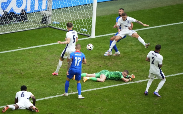 England's goalkeeper Jordan Pickford lies on the ground during a round of sixteen match between England and Slovakia at the Euro 2024 soccer tournament in Gelsenkirchen, Germany, Sunday, June 30, 2024. (AP Photo/Ebrahim Noroozi)