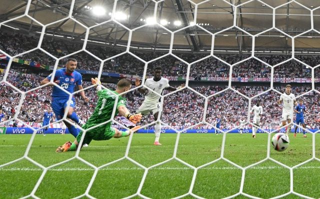 Slovakia's forward #26 Ivan Schranz scores his team's first goal past England's goalkeeper #01 Jordan Pickford during the UEFA Euro 2024 round of 16 football match between England and Slovakia at the Arena AufSchalke in Gelsenkirchen on June 30, 2024. (Photo by Ina FASSBENDER / AFP)