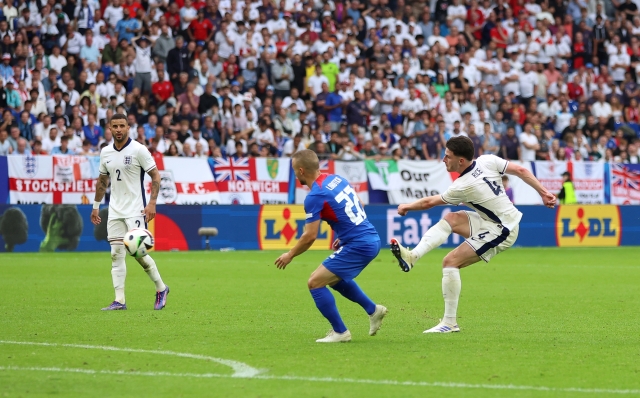 GELSENKIRCHEN, GERMANY - JUNE 30: Declan Rice of England shoots under pressure from Stanislav Lobotka of Slovakia during the UEFA EURO 2024 round of 16 match between England and Slovakia at Arena AufSchalke on June 30, 2024 in Gelsenkirchen, Germany. (Photo by Richard Pelham/Getty Images)