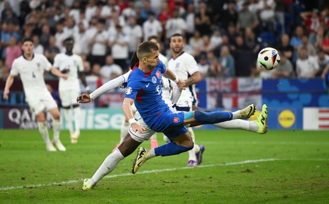 GELSENKIRCHEN, GERMANY - JUNE 30: Peter Pekarik of Slovakia shoots over whilst under pressure from Eberechi Eze of England (obscured) during the UEFA EURO 2024 round of 16 match between England and Slovakia at Arena AufSchalke on June 30, 2024 in Gelsenkirchen, Germany. (Photo by Clive Mason/Getty Images)