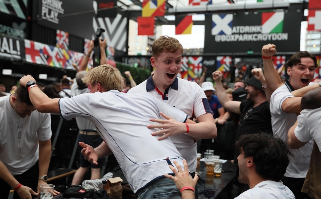 LONDON, ENGLAND - JUNE 30: England fans react as they watch a broadcast on a large screen at Boxpark Croydon of the  UEFA EURO 2024 match between England and Slovakia on June 30, 2024 in London, United Kingdom. England faces Slovakia in the UEFA EURO 2024 last-16 match in Gelsenkirchen, Germany. This is England's third appearance at this stage, having previously lost 2-1 to Iceland in 2016 and won 2-0 against Germany in 2020. (Photo by Alishia Abodunde/Getty Images)