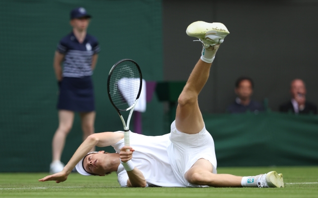 LONDON, ENGLAND - JULY 01: Jannick Sinner of Italy reacts as he falls over whilst playing against Yannick Hanfmann of Germany in the Gentlemen's Singles first round match during day one of The Championships Wimbledon 2024 at All England Lawn Tennis and Croquet Club on July 01, 2024 in London, England. (Photo by Julian Finney/Getty Images)