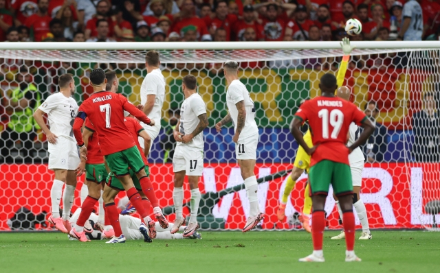 FRANKFURT AM MAIN, GERMANY - JULY 01: Cristiano Ronaldo of Portugal shoots from a free kick but misses during the UEFA EURO 2024 round of 16 match between Portugal and Slovenia at Frankfurt Arena on July 01, 2024 in Frankfurt am Main, Germany. (Photo by Lars Baron/Getty Images)