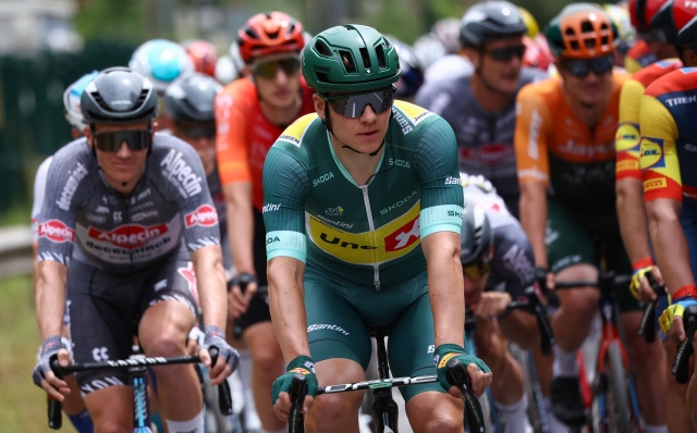 Uno-X Mobility team's Norwegian rider Jonas Abrahamsen wearing the sprinter's green jersey cycles with the pack of riders (peloton) during the 5th stage of the 111th edition of the Tour de France cycling race, 177,5 km between Saint-Jean-de-Maurienne and Saint-Vulbas, on July 3, 2024. (Photo by Anne-Christine POUJOULAT / AFP)