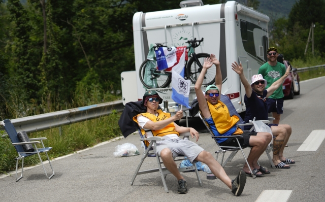 Cycling wait for the peloton to pass during the fifth stage of the Tour de France cycling race over 177.4 kilometers (110.2 miles) with start in Saint-Jean-de-Maurienne and finish in Saint-Vulbas, France, Wednesday, July 3, 2024. (AP Photo/Jerome Delay)