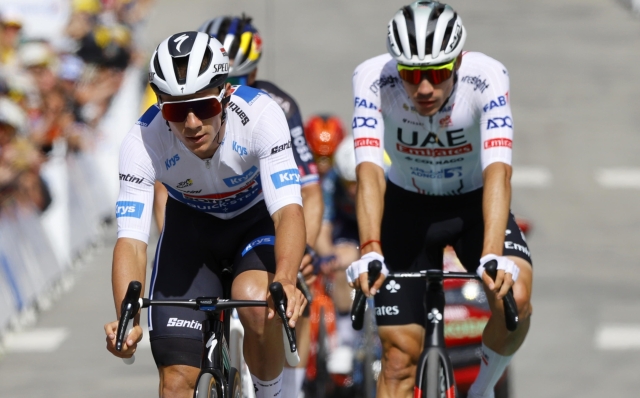 epa11452880 White jersey Belgian rider Remco Evenepoel (L) of Soudal Quick-Step crosses the finish line in second place ahead of Spanish rider Juan Ayuso (R) of UAE Team Emirates during the fourth stage of the 2024 Tour de France cycling race over 139km from Pinerolo to Valloire, France, 02 July 2024.  EPA/KIM LUDBROOK