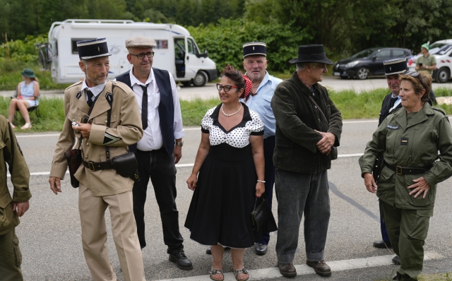 Cycling fans in historic costumes, some of them of the French Gendarmerie, wait for the riders to pass during the fifth stage of the Tour de France cycling race over 177.4 kilometers (110.2 miles) with start in Saint-Jean-de-Maurienne and finish in Saint-Vulbas, France, Wednesday, July 3, 2024. (AP Photo/Jerome Delay)