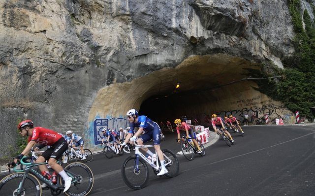 The pack passes through a tunnel during the fifth stage of the Tour de France cycling race over 177.4 kilometers (110.2 miles) with start in Saint-Jean-de-Maurienne and finish in Saint-Vulbas, France, Wednesday, July 3, 2024. (AP Photo/Jerome Delay)