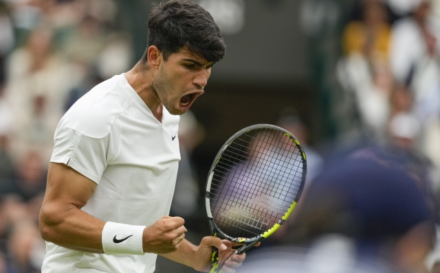 Carlos Alcaraz of Spain reacts after winning a point against Aleksandar Vukic of Australia during their match on day three at the Wimbledon tennis championships in London, Wednesday, July 3, 2024. (AP Photo/Mosa'ab Elshamy)