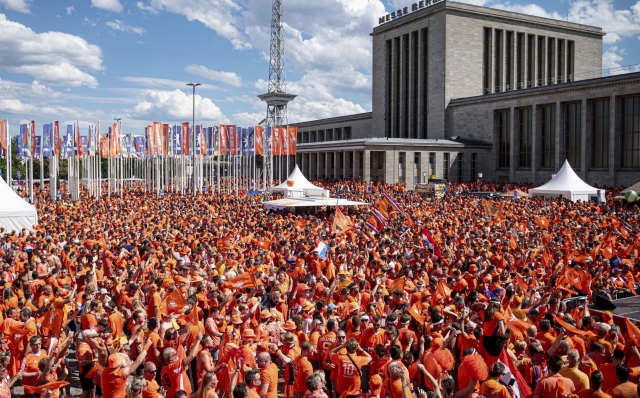 Fans of the Netherlands gather at the Berlin fair close to the Olympic stadium prior to a quarter final match between the Netherlands and Turkey at the Euro 2024 soccer tournament in Berlin, Germany, Saturday, July 6, 2024. (Fabian Sommer/dpa