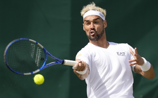 Fabio Fognini of Italy plays a forehand return to Roberto Bautista Agut of Spain during their third round match at the Wimbledon tennis championships in London, Saturday, July 6, 2024. (AP Photo/Mosa'ab Elshamy)
