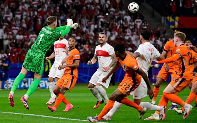 Netherlands' goalkeeper #01 Bart Verbruggen punches the ball clear during the UEFA Euro 2024 quarter-final football match between the Netherlands and Turkey at the Olympiastadion in Berlin on July 6, 2024. (Photo by JOHN MACDOUGALL / AFP)