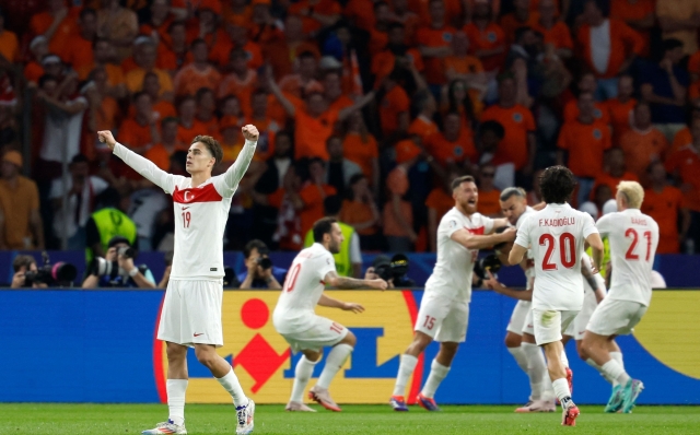 Turkey's defender #04 Samet Akaydin celebrates scoring the opening goal with his teammates during the UEFA Euro 2024 quarter-final football match between the Netherlands and Turkey at the Olympiastadion in Berlin on July 6, 2024. (Photo by Odd ANDERSEN / AFP)