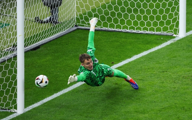 Netherlands' goalkeeper #01 Bart Verbruggen tries to make a save as the ball touches the  post during the UEFA Euro 2024 quarter-final football match between the Netherlands and Turkey at the Olympiastadion Berlin in Berlin on July 6, 2024. (Photo by Ronny HARTMANN / AFP)