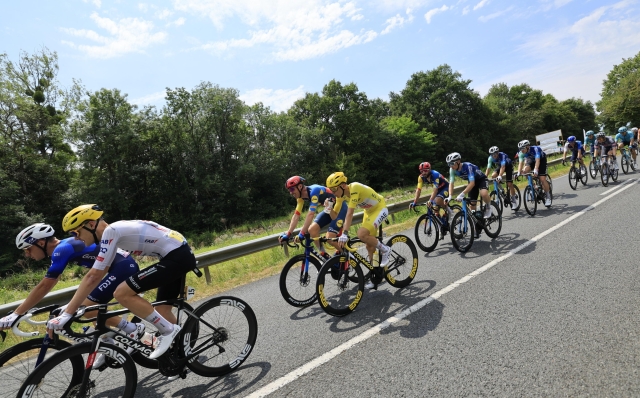 epa11468078 Yellow jersey Slovenian rider Tadej Pogacar of UAE Team Emirates hydrates next to Belgian rider Tim Declercq of Lidl-Trek during the tenth stage of the 2024 Tour de France cycling race over 187km from Orleans to Saint-Amand-Montrond, France, 09 July 2024.  EPA/GUILLAUME HORCAJUELO