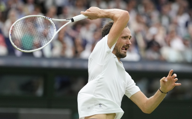 Daniil Medvedev of Russia plays a forehand return to Jannik Sinner of Italy during their quarterfinal match at the Wimbledon tennis championships in London, Tuesday, July 9, 2024. (AP Photo/Alberto Pezzali)