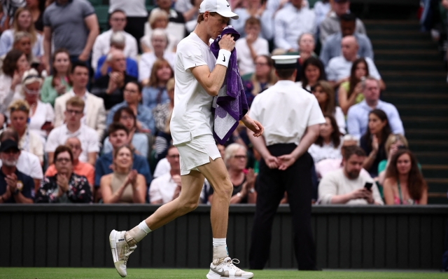 Italy's Jannik Sinner returns to court after a medical time-out in his match against Russia's Daniil Medvedev during their men's singles quarter-final tennis match on the ninth day of the 2024 Wimbledon Championships at The All England Lawn Tennis and Croquet Club in Wimbledon, southwest London, on July 9, 2024. (Photo by HENRY NICHOLLS / AFP) / RESTRICTED TO EDITORIAL USE