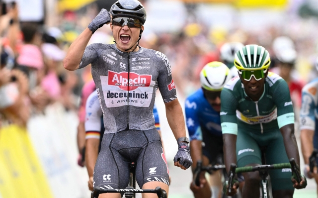 Alpecin-Deceuninck team's Belgian rider Jasper Philipsen cycles to the finish line to win ahead of second-placed Intermarche - Wanty team's Eritrean rider Biniam Girmay (R) during the 10th stage of the 111th edition of the Tour de France cycling race, 187,3 km between Orleans and Saint-Amand-Montrond, central France, on July 9, 2024. (Photo by Marco BERTORELLO / AFP)