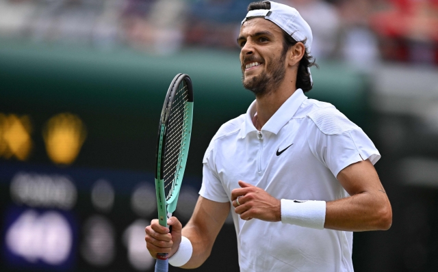 Italy's Lorenzo Musetti reacts after winning a point against US player Taylor Fritz during their men's singles quarter-finals tennis match on the tenth day of the 2024 Wimbledon Championships at The All England Lawn Tennis and Croquet Club in Wimbledon, southwest London, on July 10, 2024. (Photo by ANDREJ ISAKOVIC / AFP) / RESTRICTED TO EDITORIAL USE