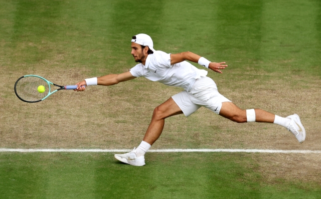 LONDON, ENGLAND - JULY 10: Lorenzo Musetti of Italy plays a forehand against Taylor Fritz of United States in the Gentlemen's Singles Quarter Final match during day ten of The Championships Wimbledon 2024 at All England Lawn Tennis and Croquet Club on July 10, 2024 in London, England. (Photo by Julian Finney/Getty Images)