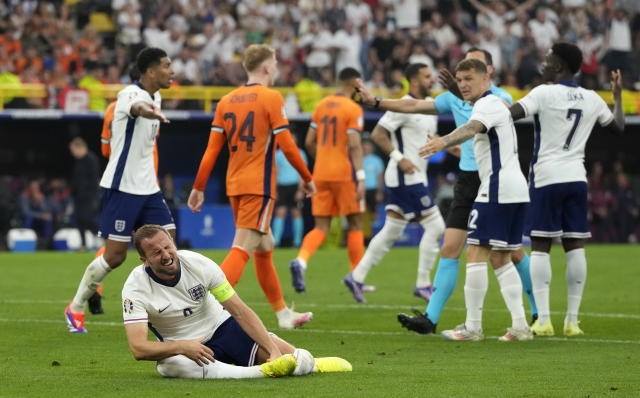 England's Harry Kane grimaces after being fouled in the penalty box during a semifinal match between the Netherlands and England at the Euro 2024 soccer tournament in Dortmund, Germany, Wednesday, July 10, 2024. (AP Photo/Frank Augstein)