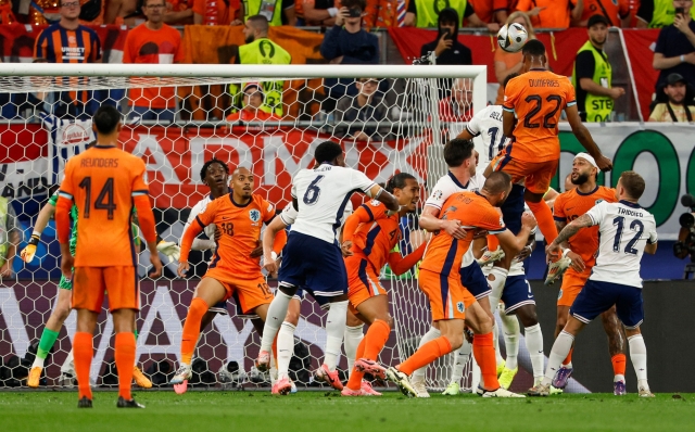 Netherlands' defender #22 Denzel Dumfries (Top R) heads the ball during the UEFA Euro 2024 semi-final football match between the Netherlands and England at the BVB Stadion in Dortmund on July 10, 2024. (Photo by Odd ANDERSEN / AFP)