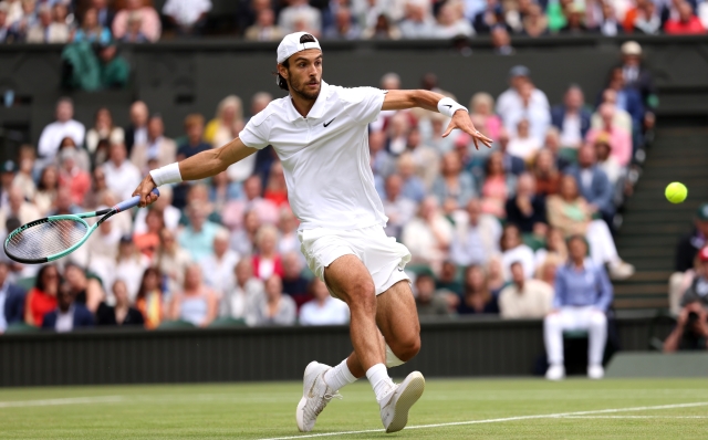 LONDON, ENGLAND - JULY 12: Lorenzo Musetti of Italy plays a forehand against Novak Djokovic of Serbia in the Gentlemen's Singles Semi-Final match during day twelve of The Championships Wimbledon 2024 at All England Lawn Tennis and Croquet Club on July 12, 2024 in London, England. (Photo by Julian Finney/Getty Images)