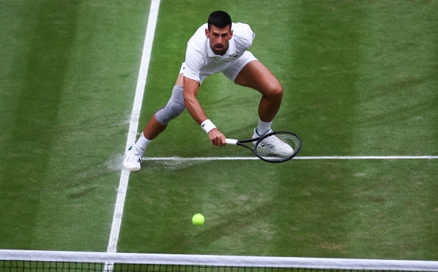 Serbia's Novak Djokovic returns against Italy's Lorenzo Musetti during their men's singles semi-final tennis match on the twelfth day of the 2024 Wimbledon Championships at The All England Lawn Tennis and Croquet Club in Wimbledon, southwest London, on July 12, 2024. (Photo by HENRY NICHOLLS / AFP) / RESTRICTED TO EDITORIAL USE