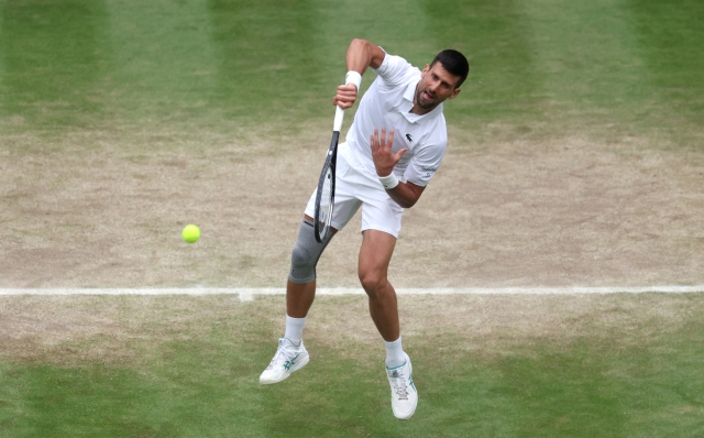 LONDON, ENGLAND - JULY 12: Novak Djokovic of Serbia serves to Lorenzo Musetti of Italy in the Gentlemen's Singles Semi-Final match during day twelve of The Championships Wimbledon 2024 at All England Lawn Tennis and Croquet Club on July 12, 2024 in London, England. (Photo by Clive Brunskill/Getty Images)