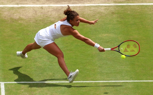 LONDON, ENGLAND - JULY 13: Jasmine Paolini of Italy plays a backhand against Barbora Krejcikova of Czechia during her Ladies' Singles Final match during day thirteen of The Championships Wimbledon 2024 at All England Lawn Tennis and Croquet Club on July 13, 2024 in London, England. (Photo by Sean M. Haffey/Getty Images)