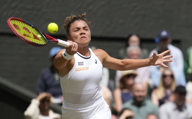 Jasmine Paolini of Italy plays a forehand return to Barbora Krejcikova of the Czech Republic during the women's singles final at the Wimbledon tennis championships in London, Saturday, July 13, 2024. (AP Photo/Mosa'ab Elshamy)