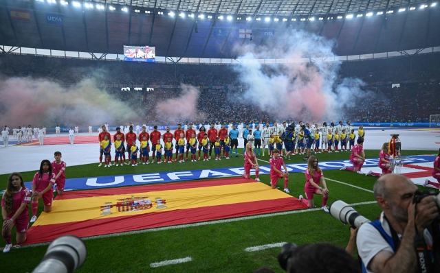 Players stand for national anthems during the UEFA Euro 2024 final football match between Spain and England at the Olympiastadion in Berlin on July 14, 2024. (Photo by Kirill KUDRYAVTSEV / AFP)