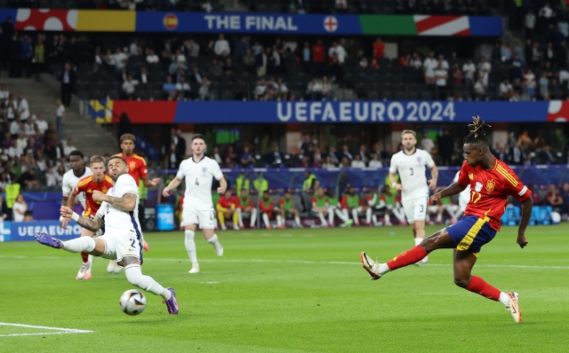 BERLIN, GERMANY - JULY 14: Nico Williams of Spain scores his team's first goal whilst under pressure from Kyle Walker of England during the UEFA EURO 2024 final match between Spain and England at Olympiastadion on July 14, 2024 in Berlin, Germany. (Photo by Richard Pelham/Getty Images)