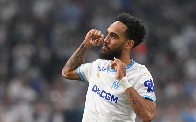 Marseille's French-Gabonese forward #10 Pierre-Emerick Aubameyang celebrates scoring his team's third goal during the French L1 football match between Olympique Marseille (OM) and FC Lorient at the Stade Velodrome in Marseille, southern France, on May 12, 2024. (Photo by Nicolas TUCAT / AFP)