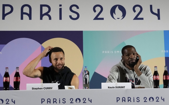 United State's men's team Kevin Durant, right, and Stephen Curry attend a press conference at the 2024 Summer Olympics, Thursday, July 25, 2024, in Paris, France. (AP Photo/Michel Euler)