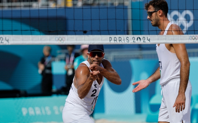 Italy's #02 Adrian Ignacio Carambula Raurich reacts next to Italy's #01 Alex Ranghieri in the men's pool B beach volleyball match between Netherlands and Italy during the Paris 2024 Olympic Games at the Eiffel Tower Stadium in Paris on July 28, 2024. (Photo by Luis TATO / AFP)
