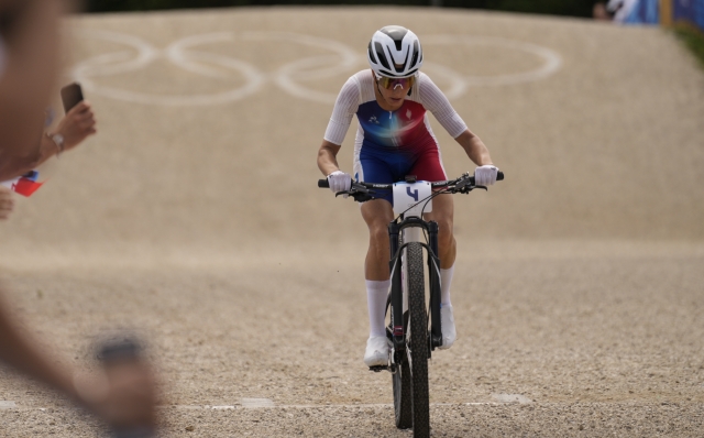 Pauline Ferrand Prevot, of France, comes in for the final lap as she competes in the women's mountain bike cycling event, at the 2024 Summer Olympics, Sunday, July 28, 2024, in Elancourt, France. (AP Photo/George Walker IV)