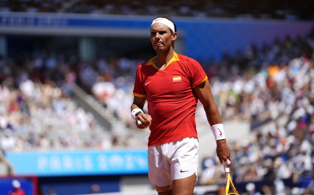 Spain's Rafael Nadal walks backs as he plays Serbia's Novak Djokovic during their men's singles second round match at the 2024 Summer Olympics, Monday, July 29, 2024, at the Roland Garros stadium in Paris, France. (AP Photo/Manu Fernandez)