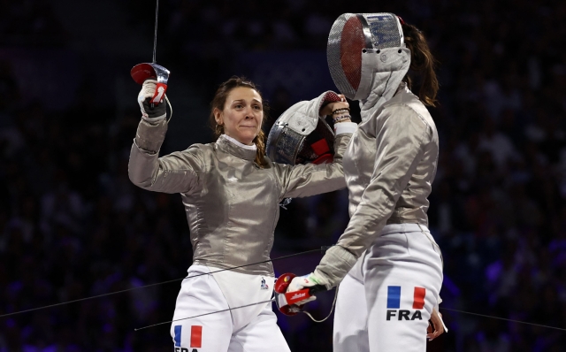 France's Manon Apithy-Brunet competes against France's Sara Balzer in the women's sabre individual gold medal bout during the Paris 2024 Olympic Games at the Grand Palais in Paris, on July 29, 2024. (Photo by Franck FIFE / AFP)