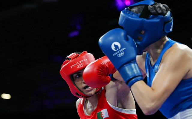 Algeria's Imane Khelif (in red) fights against Italy's Angela Carini in the women's 66kg preliminaries round of 16 boxing match during the Paris 2024 Olympic Games at the North Paris Arena, in Villepinte on August 1, 2024. (Photo by MOHD RASFAN / AFP)