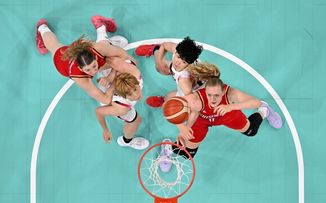 LILLE, FRANCE - AUGUST 01: (EDITORS NOTE: Image was captured using a robotic camera positioned above the field of play.)  Maki Takada #8 and Himawari Akaho #88 of Team Japan compete for the ball against Marie Guelich #11 of Team Germany Women's Group Phase - Group C match between Team Japan and Team Germany on day six of the Olympic Games Paris 2024 at Stade Pierre Mauroy on August 01, 2024 in Lille, France. (Photo by Pool/Getty Images)