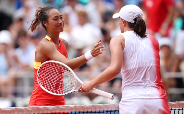 PARIS, FRANCE - AUGUST 01: Qinwen Zheng of Team People's Republic of China celebrates victory against Iga Swiatek of Team Poland during the Women's Singles Semi-final match on day six of the Olympic Games Paris 2024 at Roland Garros on August 01, 2024 in Paris, France. (Photo by Matthew Stockman/Getty Images)