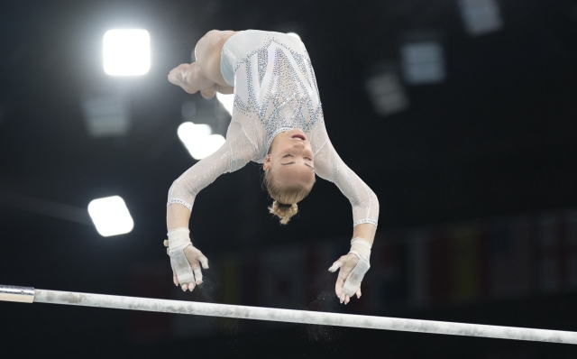 Alice D'Amato, of Italy, performs on the uneven bars during the women's artistic gymnastics team finals round at Bercy Arena at the 2024 Summer Olympics, Tuesday, July 30, 2024, in Paris, France. (AP Photo/Charlie Riedel)