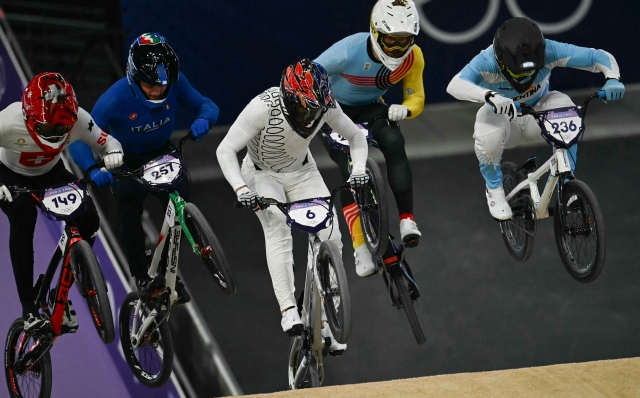 (From L) Switzerland's #149 Cedric Butti, Italy's #257 Pietro Bertagnoli, New Zealand's #06 Rico Bearman, and Argentina's #236 Gonzalo Nahuel Molina compete in the third heat of the second run of the Men's Cycling BMX Racing quarterfinals during the Paris 2024 Olympic Games in Saint-Quentin-en-Yvelines, on August 1, 2024. (Photo by Mauro PIMENTEL / AFP)