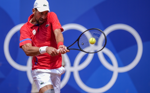 Serbia's Novak Djokovic returns the ball against Germany's Dominik Koepfer during the men's single tennis competition at the Roland Garros stadium, at the 2024 Summer Olympics, Wednesday, July 31, 2024, in Paris, France. (AP Photo/Manu Fernandez)